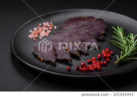 Delicious dried smoked beef or horse meat jerky with spices and salt 101910442