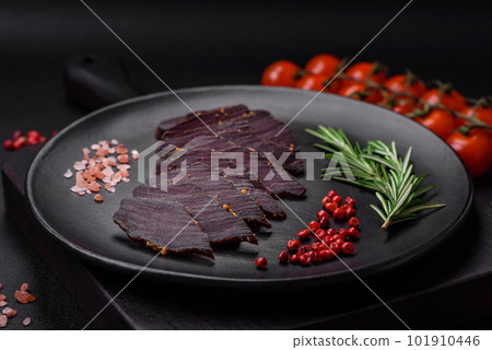 Delicious dried smoked beef or horse meat jerky with spices and salt Delicious dried smoked beef or horse meat jerky with spices and salt 101910446