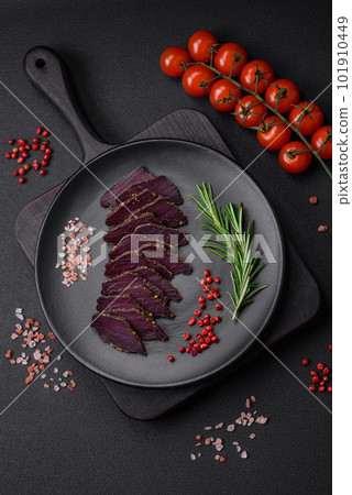 Delicious dried smoked beef or horse meat jerky with spices and salt 101910449