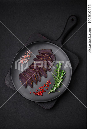 Delicious dried smoked beef or horse meat jerky with spices and salt Delicious dried smoked beef or horse meat jerky with spices and salt 101910453