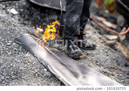 heating the asphalt with a flame. waterproofing of the foundation and walls of the house 101910735