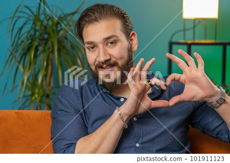 Happy lebanese man guy makes symbol of love showing heart sign to camera express romantic feelings Happy lebanese man guy makes symbol of love showing heart sign to camera express romantic feelings 101911123