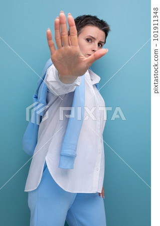 young indignant dude woman in casual look shows refusal gesture young indignant dude woman in casual look shows refusal gesture 101911348