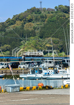 The white Nichinan Line Kiha 40 running through the fresh green fishing port The white Nichinan Line Kiha 40 running through the fresh green fishing port 101911353