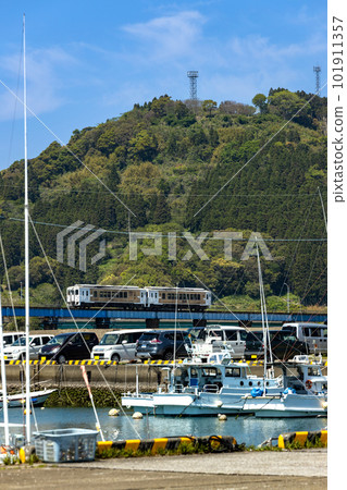 The Nichinan Line Limited Express Umisachi Yamasachi Train that runs through a fishing port surrounded by fresh greenery The Nichinan Line Limited Express Umisachi Yamasachi Train that runs through a fishing port surrounded by fresh greenery 101911357