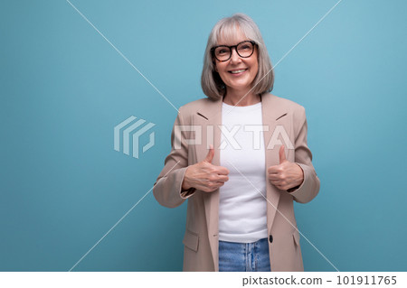 successful business 60s woman in stylish look on studio background with copy space 101911765