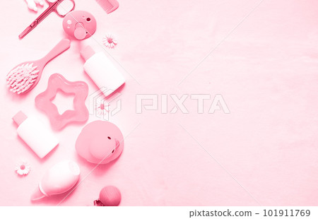 Different baby care accessories on the left on the background. New 2023 trendy color - Viva Magenta. Different baby care accessories on the left on the background. New 2023 trendy color - Viva Magenta. 101911769