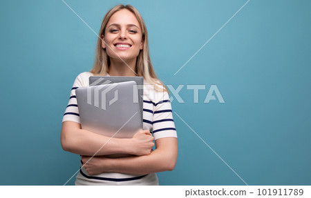 smart successful confident girl student with a laptop in her hands on a blue isolated background smart successful confident girl student with a laptop in her hands on a blue isolated background 101911789