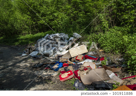 Unauthorized garbage dump near the road in a natural park area. Unauthorized garbage dump near the road in a natural park area. 101911886