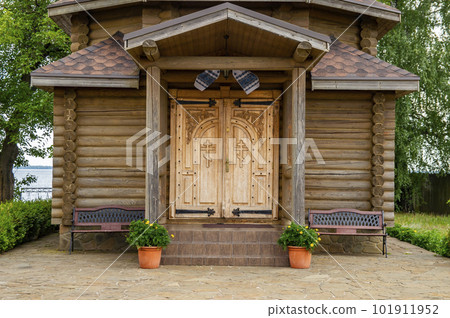 A Christian temple made of a wooden frame with a golden dome and a cross. 101911952