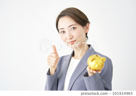 Business woman holding a piggy bank and giving a good sign White background 101914965