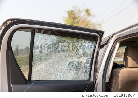 Cracked side car window glass on road . Damaged car window. .Car accident claims via insurance apps. 101915807
