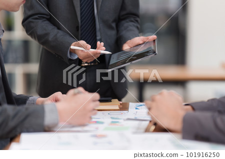 Close up of Diverse colleagues gather brainstorm discuss financial statistics at office meeting. finance, teamwork, Big data Graphs Charts concept 101916250