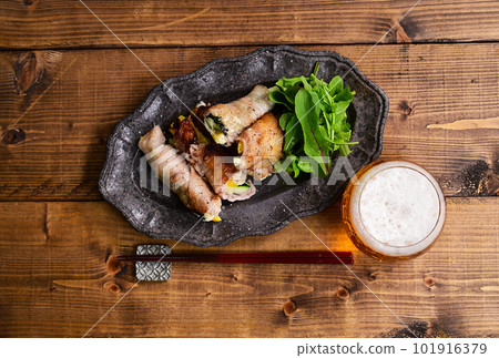 Zucchini and paprika pork belly roll 101916379