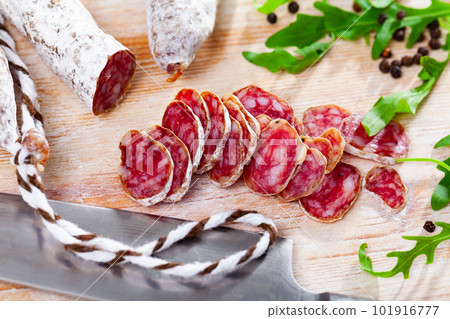 Traditional spanish thin salami sausage Fuet, sliced Traditional spanish thin salami sausage Fuet, sliced 101916777