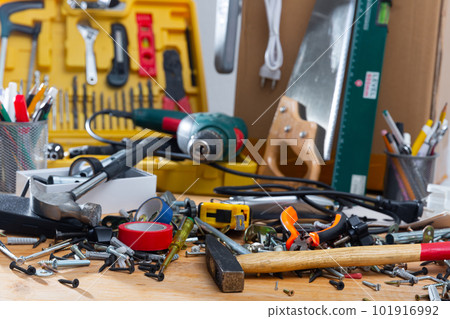 Hand tools in mess on wooden table Hand tools in mess on wooden table 101916992