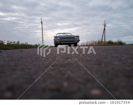 Blue car parked on the road against the background of the sunny sky. Retrocar 101917354