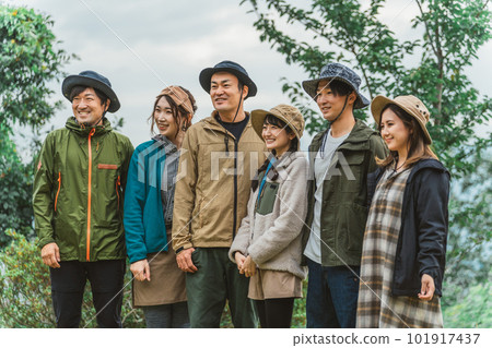 Side profile of male and female Asian campers camping in autumn and winter with friends 101917437