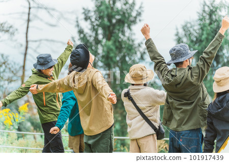 Rear view of male and female Asian camper friends who have hobbies to play in nature such as camping, glamping, mountaineering 101917439