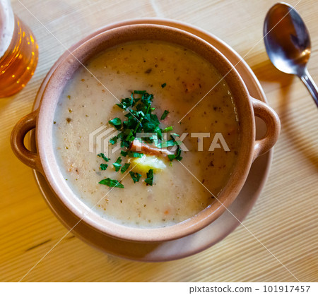 Zurek cream soup served with greens in bowl on table 101917457