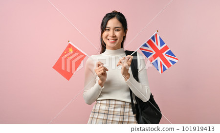 Pretty girl showing a United Kingdom and china flag on pink isolated background 101919413