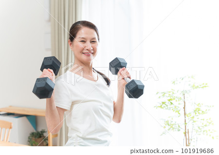 Healthy senior woman doing muscle training with dumbbells Healthy senior woman doing muscle training with dumbbells 101919686
