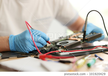 Master in gloves checks condition of printed circuit board 101920429