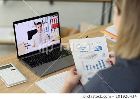 Woman examines investigation paper talking to man on video 101920434