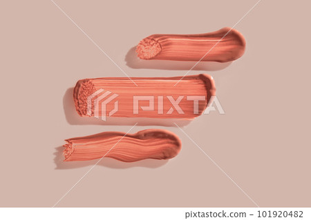 Three strokes of lip gloss on a beige background. 101920482
