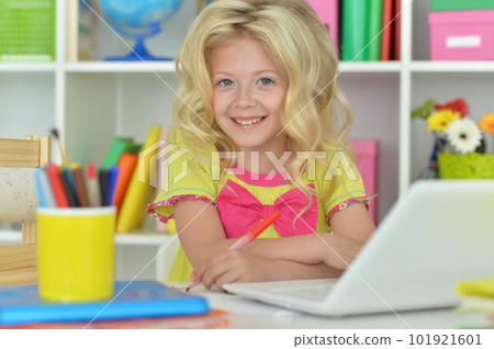 girl using laptop at desk at home girl using laptop at desk at home 101921601