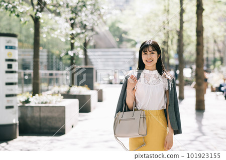 A young lady walking in the city 101923155