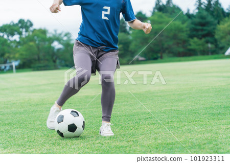 Feet of a woman dribbling a soccer ball Feet of a woman dribbling a soccer ball 101923311