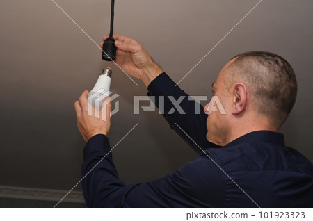 energy saving. incandescent lamp and energy-efficient LED lamp in your hands. concept.  101923323