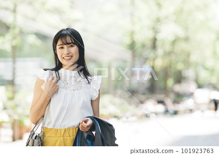 A young lady walking in the city 101923763