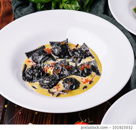 black ravioli with red caviar in white plate black ravioli with red caviar in white plate 101925032