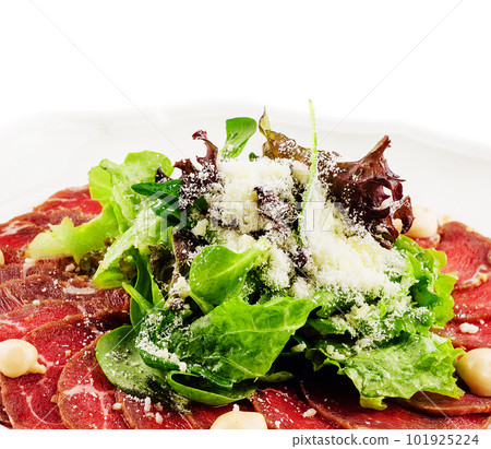 Veal carpaccio with parmesan cheese on white plate 101925224