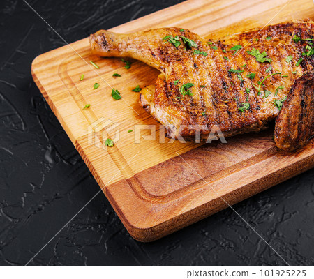 grilled bbq crispy chicken leg quarter on the wood board 101925225