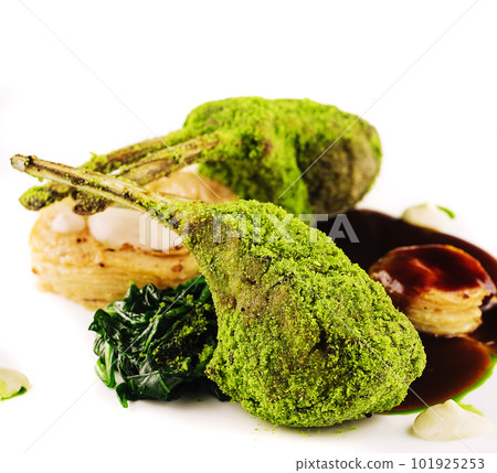 Grilled rack of lamb with mint and pistachio on plate 101925253