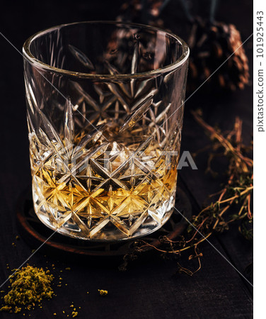 Glass of whiskey on wooden table 101925443