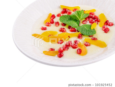 Plate of oatmeal with porridge , dried apricots and pomegranates 101925452