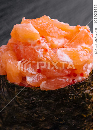 Gunkan with salmon on black wood background Gunkan with salmon on black wood background 101925453