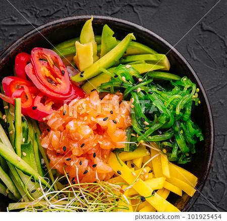 Hawaiian salmon poke bowl with seaweed, avocado, sesame seeds and cucumber 101925454