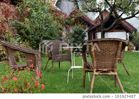 Rattan chairs and white table 101925487