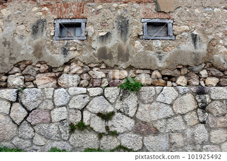 Background of stone wall with small wooden windows Background of stone wall with small wooden windows 101925492