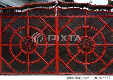 Detail of a red forged metallic gate Detail of a red forged metallic gate 101925554
