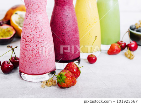 Four different smoothies of berry, banana with tangerine, kiwi, strawberries 101925567