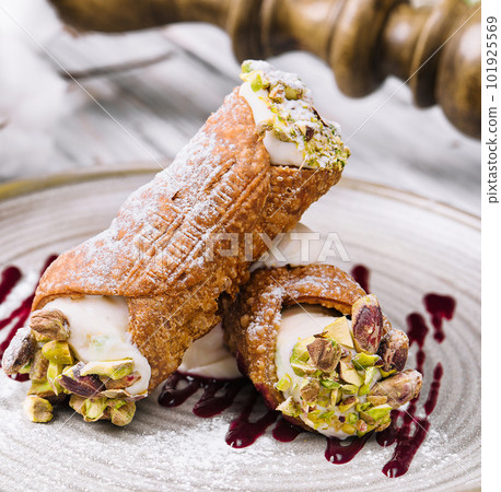 Traditional italian dessert cannoli siciliani on plate 101925569