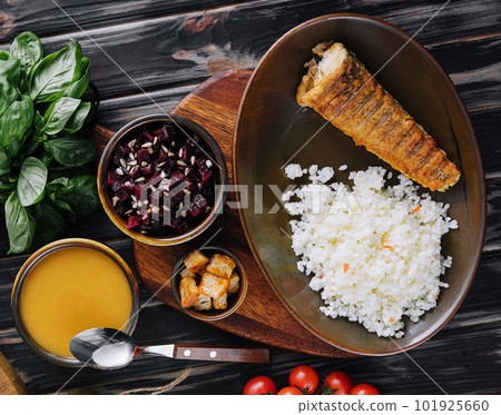Roast fish with white rice on a cutting board Roast fish with white rice on a cutting board 101925660
