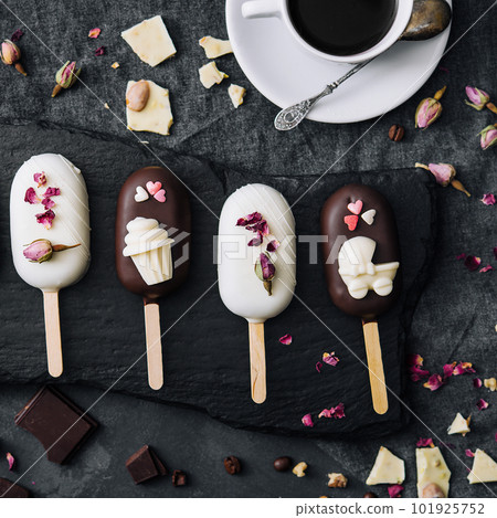Top view of decorated cake pops ice creams on black background 101925752