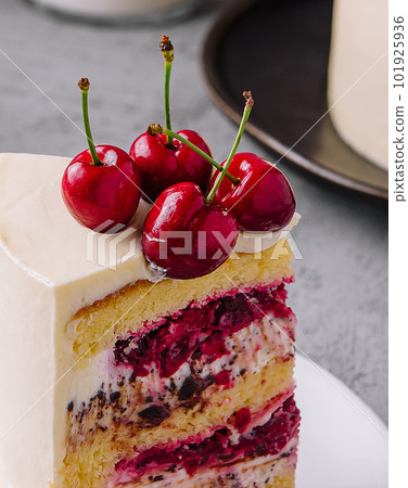 A piece of milk cake with cherries close up A piece of milk cake with cherries close up 101925936
